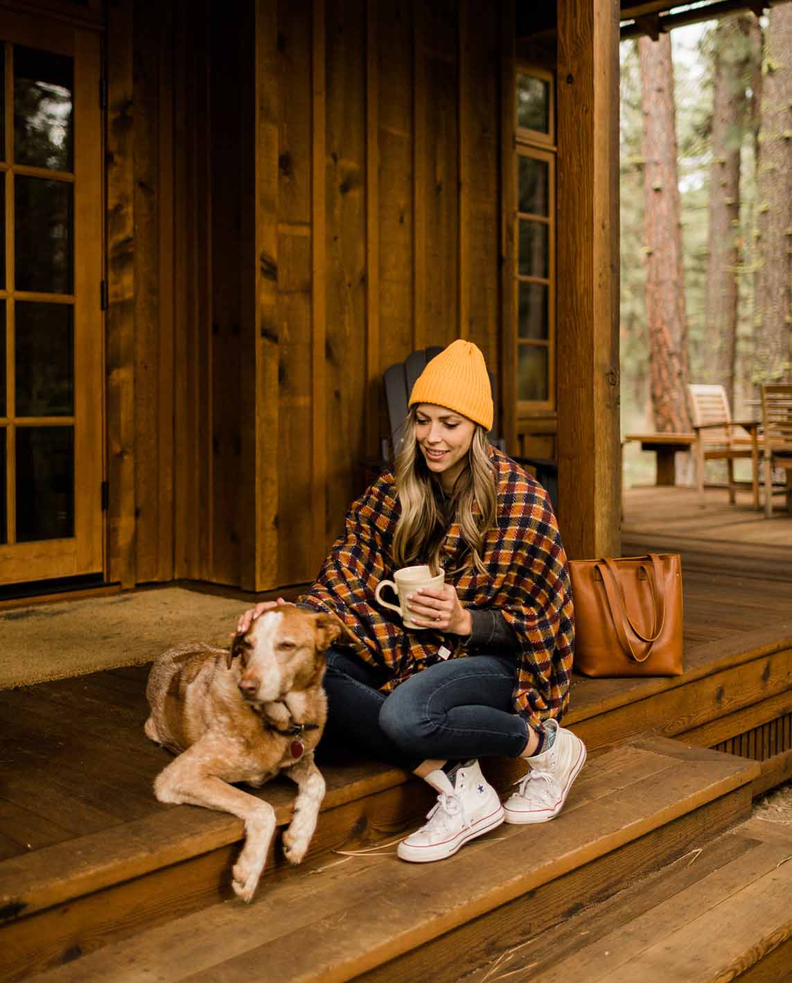woman and dog outside metolious river cabin