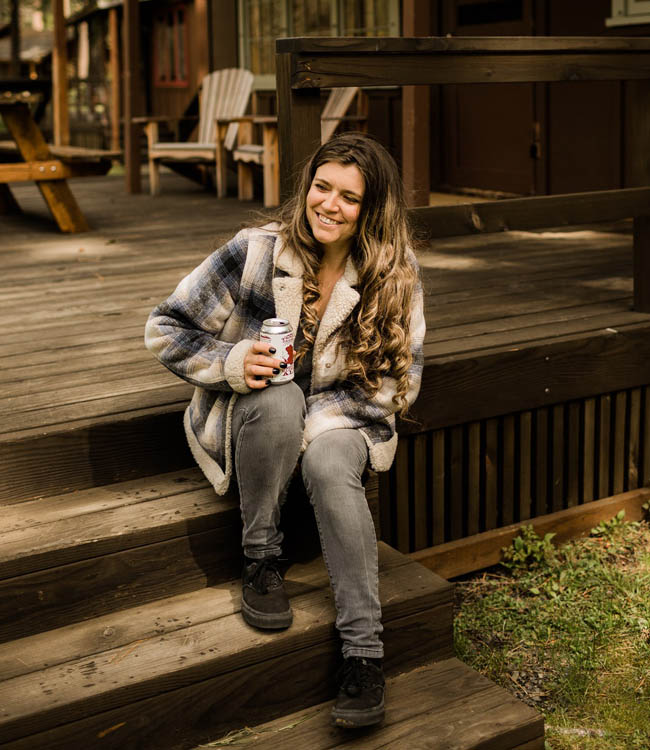 woman drinking beer in nature